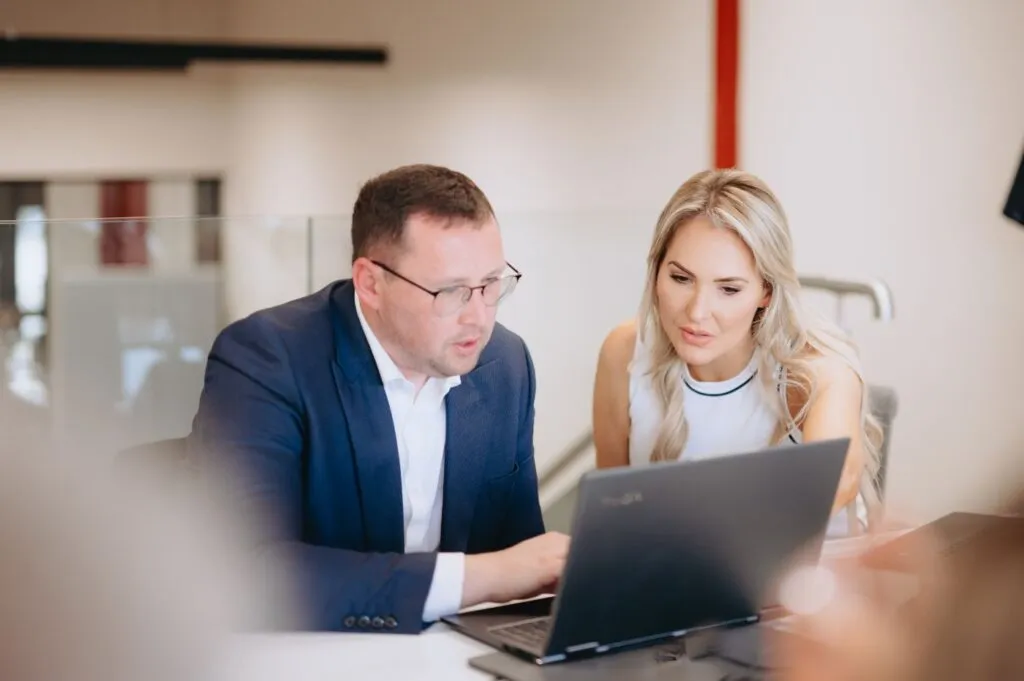 Two colleagues working together at a laptop